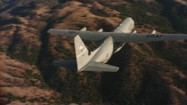 4K stock footage aerial video of flying around the tail of a Lockheed Martin C-130J at sunset in Northern California  Aerial Stock Footage | WAAF06_C021_01198P