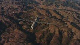 4K stock footage aerial video of flying around the front of a Lockheed Martin C-130J at sunset in Northern California Aerial Stock Footage | WAAF06_C024_0119KD