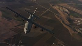 4K stock footage aerial video of flying around the front end of a Lockheed Martin C-130J at sunset, Northern California Aerial Stock Footage | WAAF06_C026_0119G8