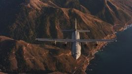 4K stock footage aerial video reverse view of a Lockheed Martin C-130J flying over mountains near coast of Northern California Aerial Stock Footage | WAAF06_C052_0119WK