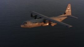 4K stock footage aerial video of a Lockheed Martin C-130J flying over the ocean at sunset, Northern California Aerial Stock Footage | WAAF06_C067_011987