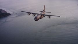 4K stock footage aerial video of a Lockheed Martin C-130J flying over the ocean toward San Francisco Bay at sunset, California  Aerial Stock Footage | WAAF06_C085_0119X1