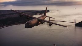 4K stock footage aerial video of a Lockheed Martin C-130J flying over the Golden Gate Bridge at sunset, California Aerial Stock Footage | WAAF06_C087_0119KX