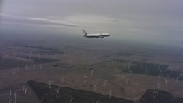 4K stock footage aerial video of tracking a Boeing C-32 over windmills in Northern California Aerial Stock Footage | WAAF08_C008_0119F0