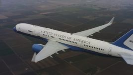 4K stock footage aerial video of a Boeing C-32 in the air above farmland in Northern California Aerial Stock Footage | WAAF08_C024_0119EQ_S001