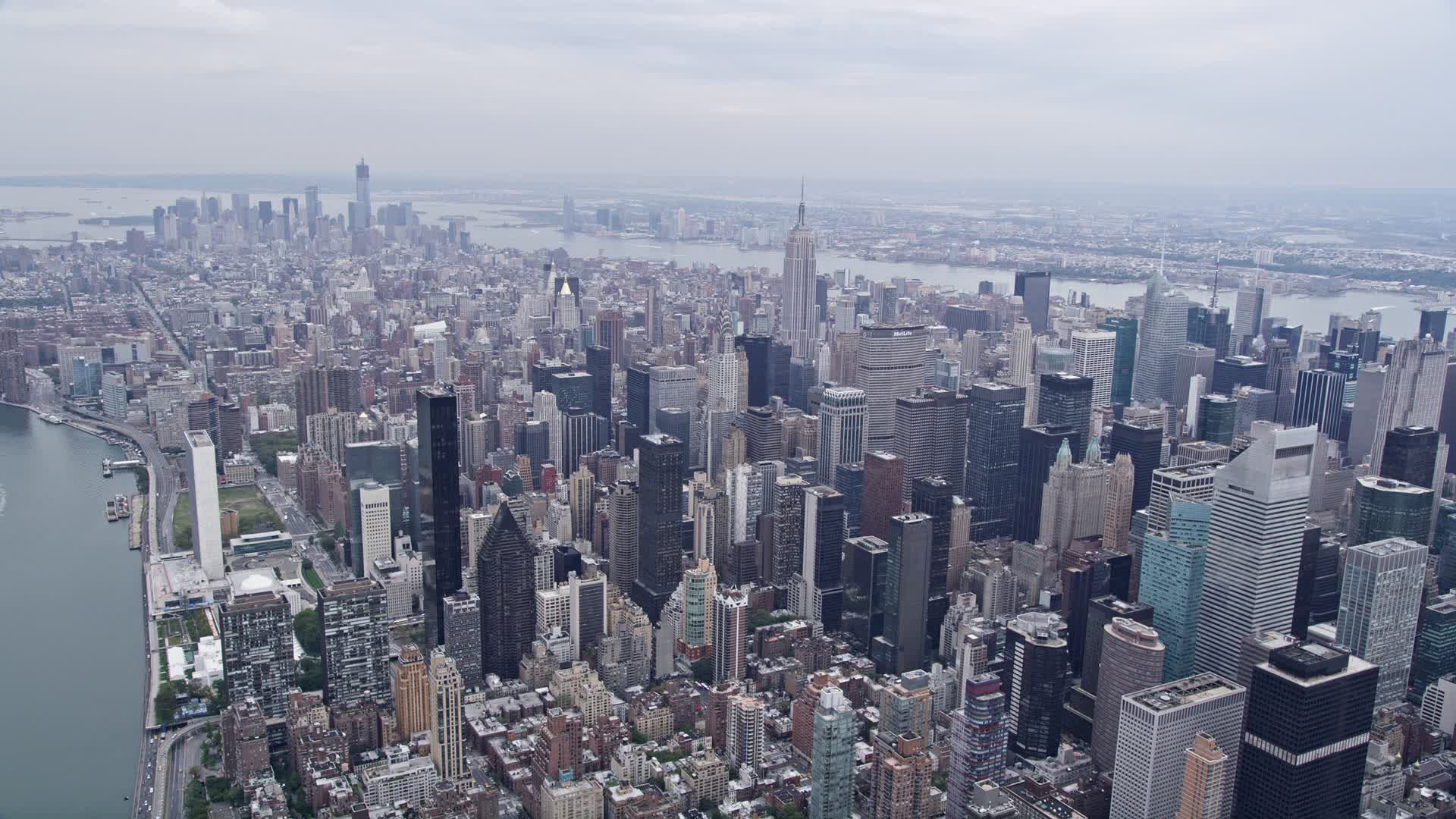 4K stock footage aerial video flying by Midtown Manhattan with view of ...