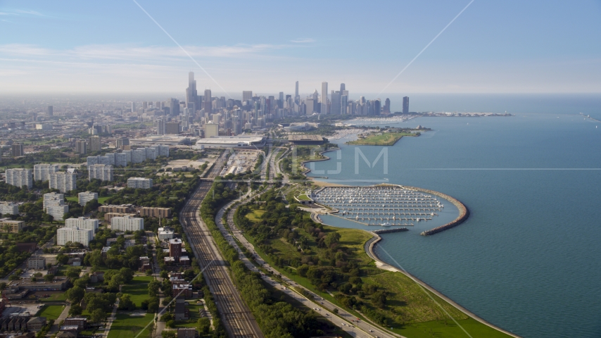 The Downtown Chicago skyline and Lake Michigan, on a hazy day, Illinois Aerial Stock Photo AX0001_014.0000123F | Axiom Images