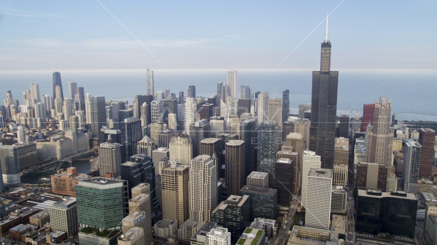 A view across Downtown Chicago on a hazy day, from Willis Tower to John Hancock Center, Illinois Aerial Stock Photo AX0001_069.0000169F | Axiom Images