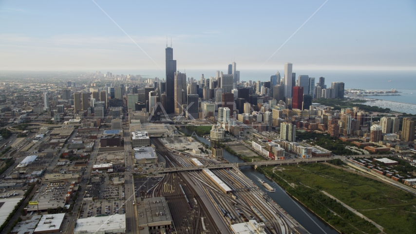 Train yards by the Chicago River near the downtown skyline on a hazy day, Downtown Chicago, Illinois Aerial Stock Photo AX0001_076.0000284F | Axiom Images