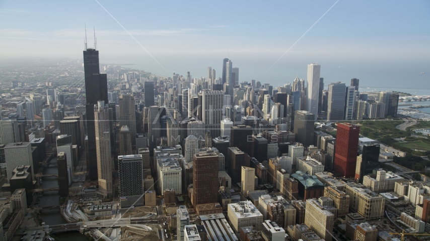 The iconic Willis Tower skyscraper and Downtown Chicago buildings on a hazy day, Illinois Aerial Stock Photo AX0001_079.0000236F | Axiom Images
