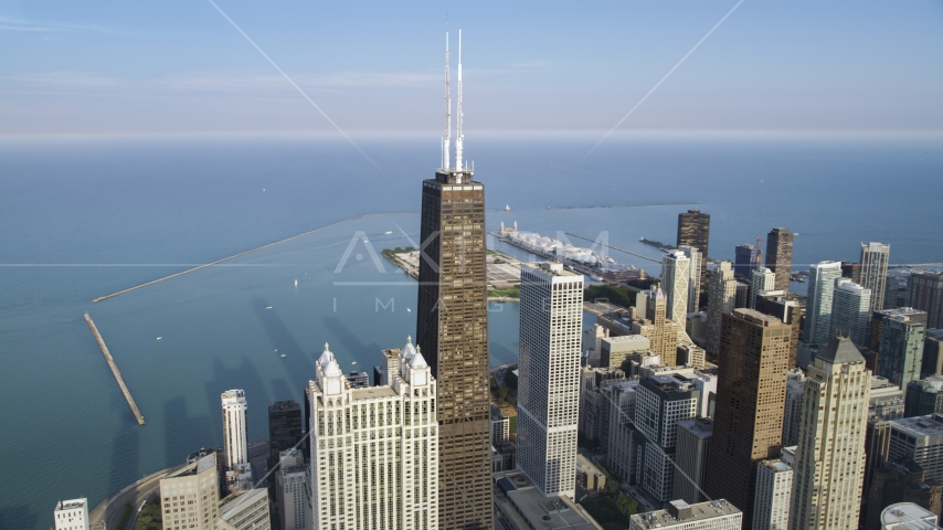 The John Hancock Center skyscraper with Navy Pier in the background, Downtown Chicago, Illinois Aerial Stock Photo AX0001_087.0000290F | Axiom Images