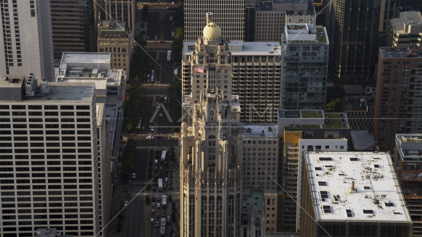 A flag flying at top of Tribune Tower in Downtown Chicago, Illinois Aerial Stock Photo AX0001_118.0000016F | Axiom Images