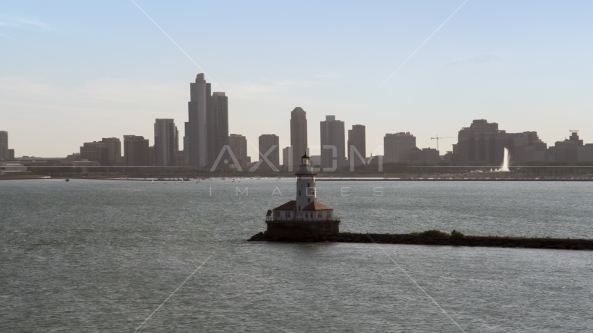 Chicago Harbor Lighthouse, and the Downtown Chicago skyline in the distance, Illinois Aerial Stock Photo AX0002_048.0000171F | Axiom Images