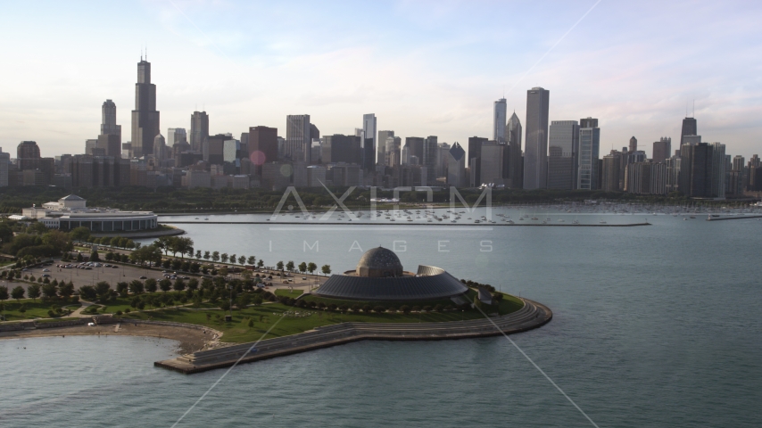 The Adler Planetarium and Astronomy Museum with the Downtown Chicago skyline and harbor in background, Illinois Aerial Stock Photo AX0002_086.0000203F | Axiom Images