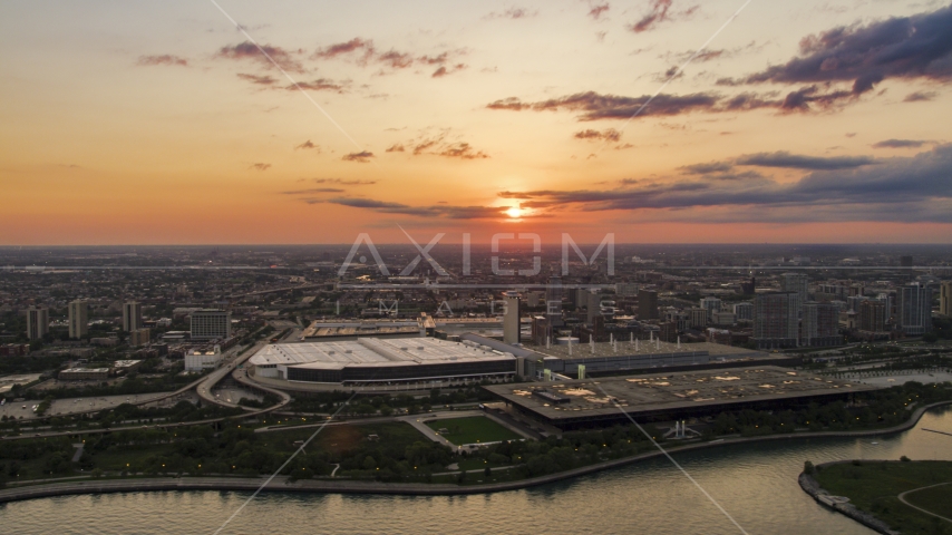 McCormick Place convention center with setting sun and clouds in distance, Chicago, Illinois Aerial Stock Photo AX0003_028.0000153F | Axiom Images