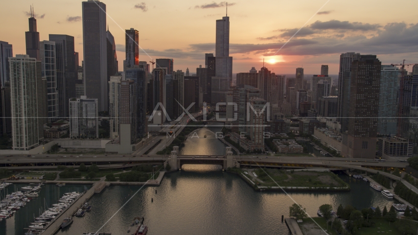 The bridge at mouth of Chicago River near downtown buildings at sunset, Downtown Chicago, Illinois Aerial Stock Photo AX0003_035.0000000F | Axiom Images