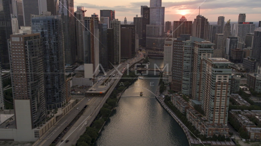 The Chicago River lined city buildings at sunset, Downtown Chicago, Illinois Aerial Stock Photo AX0003_035.0000326F | Axiom Images