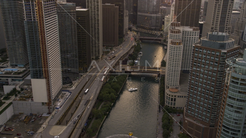 A bridge spanning the Chicago River through Downtown Chicago, Illinois at sunset Aerial Stock Photo AX0003_036.0000250F | Axiom Images