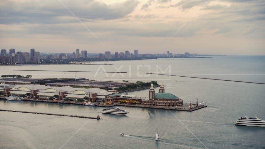 Two ferries by the end of the Navy Pier on a cloudy day at sunset, Chicago, Illinois Aerial Stock Photo AX0003_063.0000418F | Axiom Images