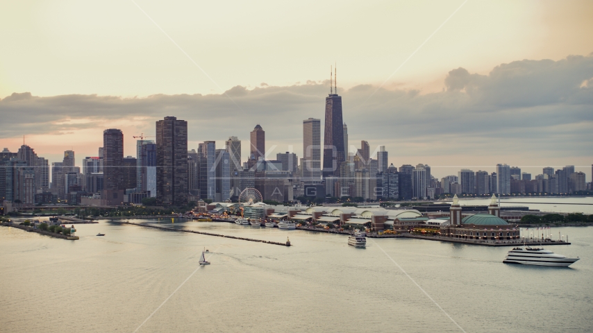Navy Pier and the Downtown Chicago skyline on a cloudy day at sunset, Illinois Aerial Stock Photo AX0003_064.0000424F | Axiom Images