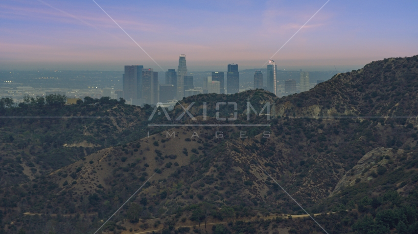 Downtown Los Angeles seen from behind a hill, twilight, California Aerial Stock Photo AX0158_004.0000052 | Axiom Images