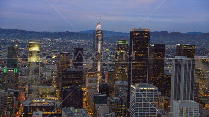 Wilshire Grand Center and nearby skyscrapers at twilight in Downtown Los Angeles, California Aerial Stock Photo AX0158_047.0000110 | Axiom Images