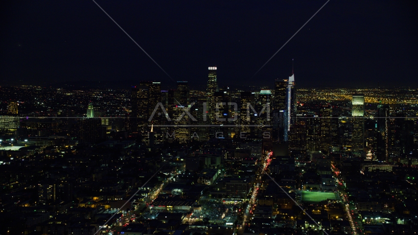 Towering skyscrapers of the city's skyline at night in Downtown Los Angeles, California Aerial Stock Photo AX0158_085.0000268 | Axiom Images