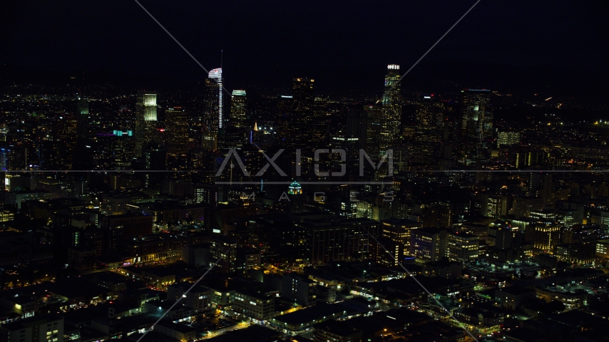 The city skyline's tall skyscrapers at night in Downtown Los Angeles, California Aerial Stock Photo AX0158_093.0000359 | Axiom Images
