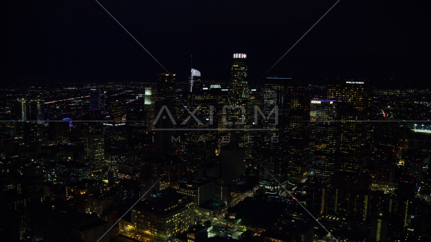 Tall city skyscrapers at night in Downtown Los Angeles, California Aerial Stock Photo AX0158_110.0000136 | Axiom Images