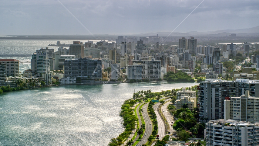 Waterfront apartment buildings and rain, San Juan, Puerto Rico Aerial Stock Photo AX101_003.0000154F | Axiom Images