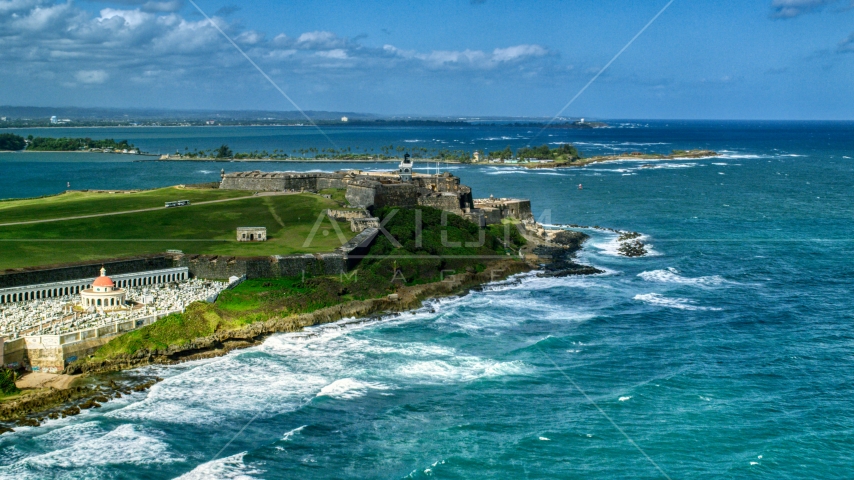 Historic fort on the coast by clear blue water, Old San Juan, Puerto Rico Aerial Stock Photo AX101_011.0000000F | Axiom Images