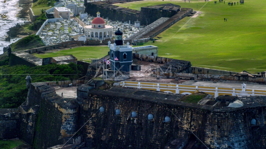 Historic fort and lighthouse on the coast, Old San Juan, Puerto Rico Aerial Stock Photo AX101_022.0000351F | Axiom Images