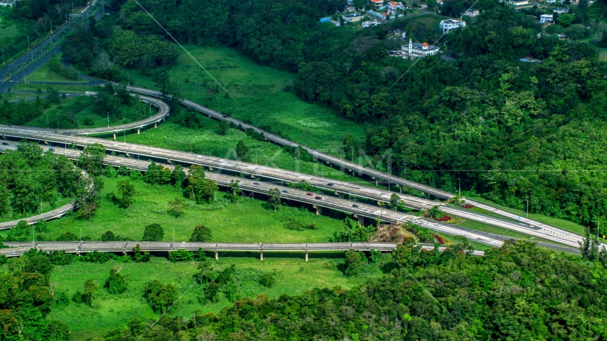 Highway cutting through rural area of grass and trees, Vega Alta, Puerto Rico  Aerial Stock Photo AX101_036.0000398F | Axiom Images
