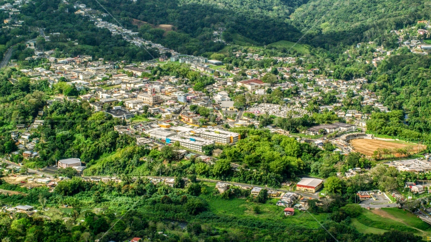 The small town of Ciales, surrounded by trees in Puerto Rico  Aerial Stock Photo AX101_046.0000180F | Axiom Images