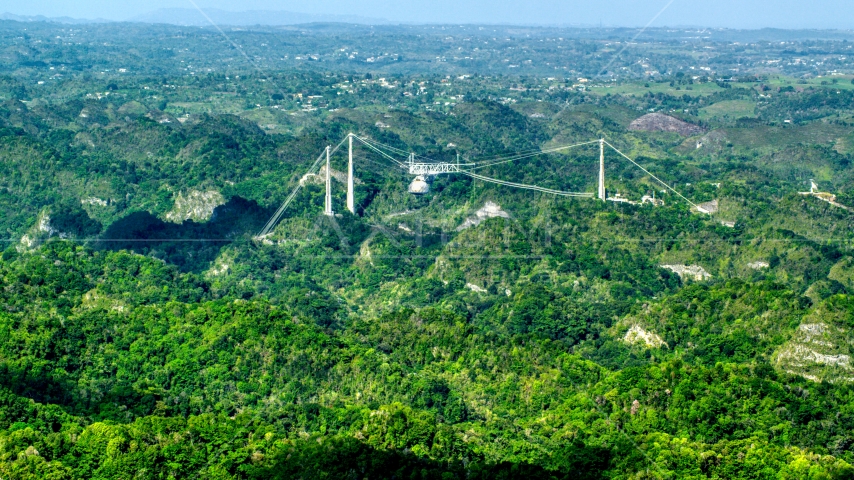 Arecibo Observatory rising above the lush green Karst Forest, Puerto Rico  Aerial Stock Photo AX101_087.0000000F | Axiom Images