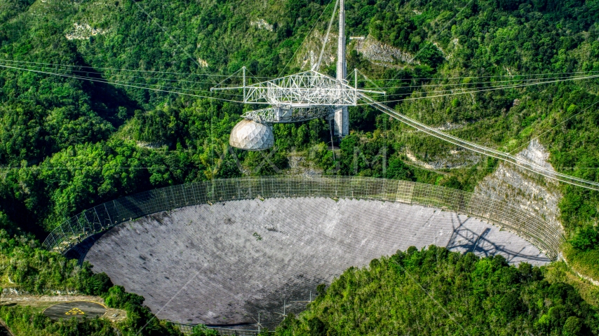 The Arecibo Observatory located in the lush green Karst forest of Puerto Rico Aerial Stock Photo AX101_091.0000123F | Axiom Images
