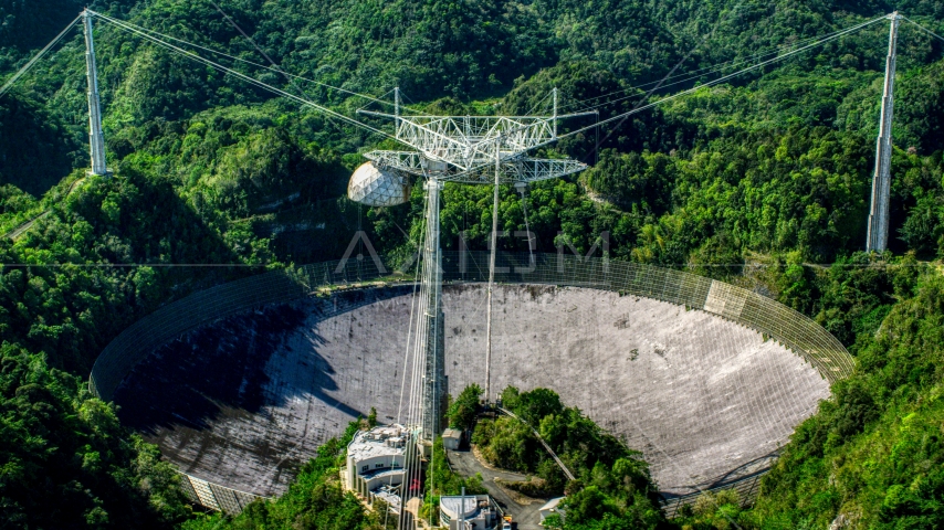 Arecibo Observatory in lush green Karst forest, Puerto Rico Aerial Stock Photo AX101_093.0000000F | Axiom Images