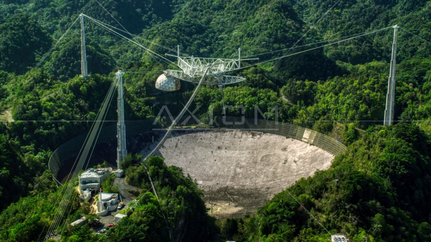 A view of the Arecibo Observatory surrounded by trees, Puerto Rico Aerial Stock Photo AX101_105.0000000F | Axiom Images