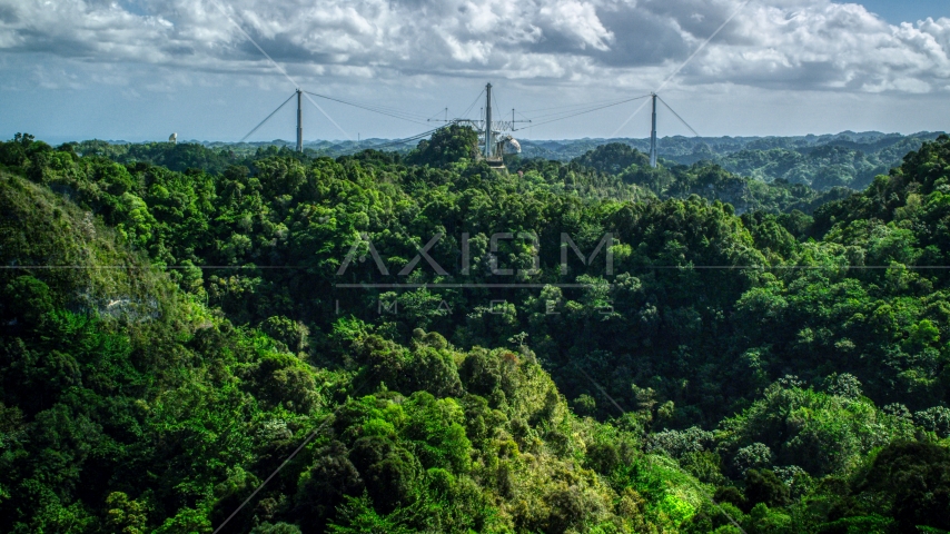 Arecibo Observatory seen from lush green mountains, Puerto Rico  Aerial Stock Photo AX101_108.0000184F | Axiom Images