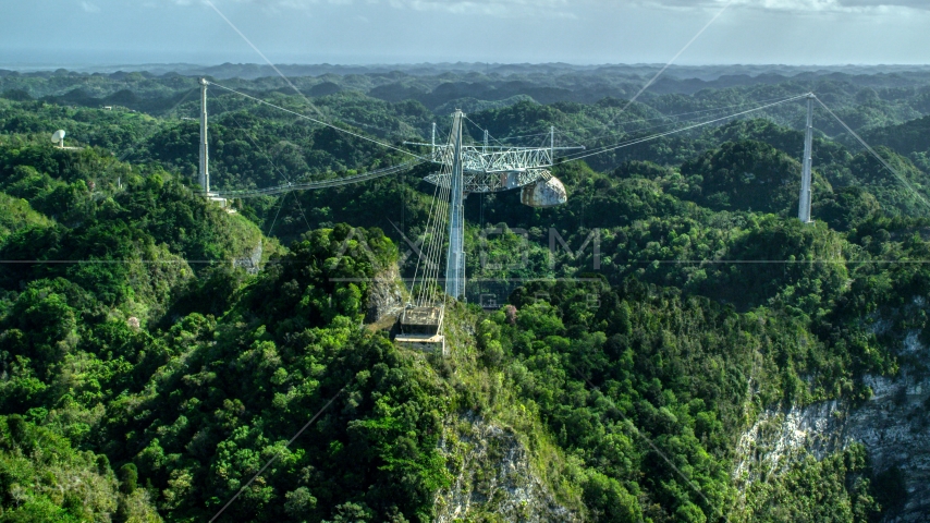 Top of Arecibo Observatory rising about karst mountains, Puerto Rico  Aerial Stock Photo AX101_111.0000000F | Axiom Images