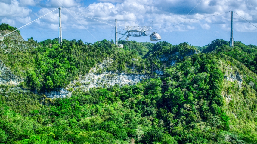 Top of the Arecibo Observatory seen above karst mountains, Puerto Rico Aerial Stock Photo AX101_114.0000000F | Axiom Images