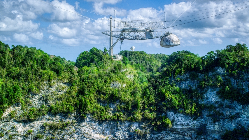Top structure of the Arecibo Observatory and karst mountains in Puerto Rico Aerial Stock Photo AX101_116.0000000F | Axiom Images