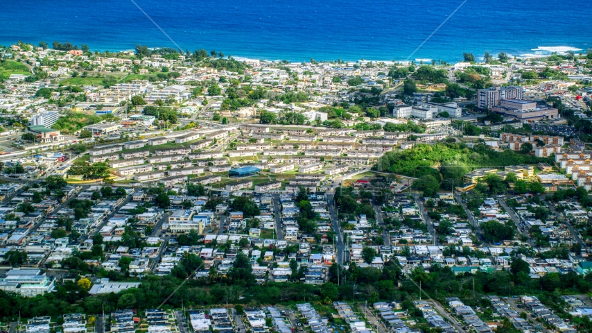 Coastal homes and apartment buildings in Arecibo, Puerto Rico  Aerial Stock Photo AX101_134.0000081F | Axiom Images