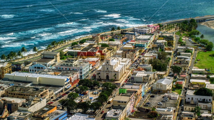 Coastal buildings and Catedral San Felipe, Arecibo Puerto Rico Aerial Stock Photo AX101_138.0000000F | Axiom Images