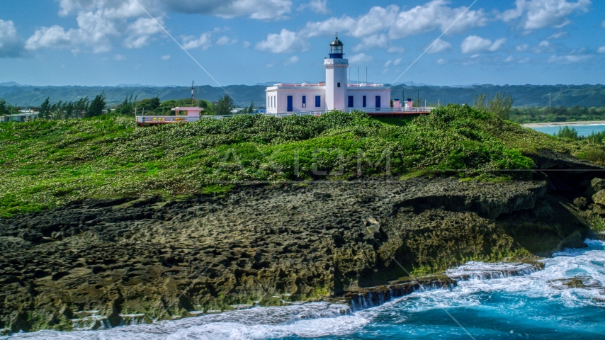 The Arecibo Lighthouse on the island coast, Puerto Rico Aerial Stock Photo AX101_148.0000000F | Axiom Images