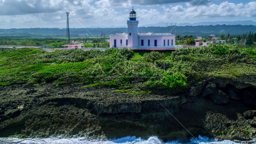 The Arecibo Lighthouse overlooking the island coast, Puerto Rico Aerial Stock Photo AX101_148.0000244F | Axiom Images