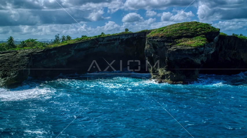 Rugged rock formation on the Caribbean island coast in Arecibo, Puerto Rico  Aerial Stock Photo AX101_162.0000151F | Axiom Images