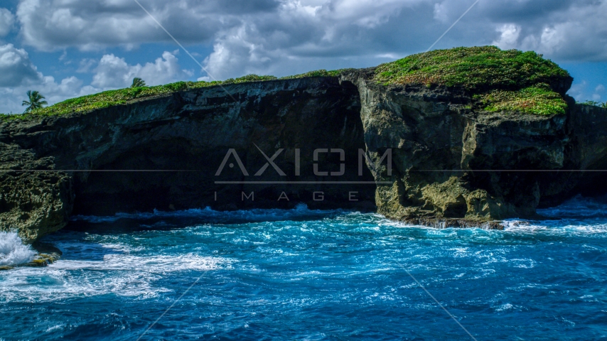 Crystal blue water and a shallow sea cave in Arecibo, Puerto Rico  Aerial Stock Photo AX101_165.0000270F | Axiom Images