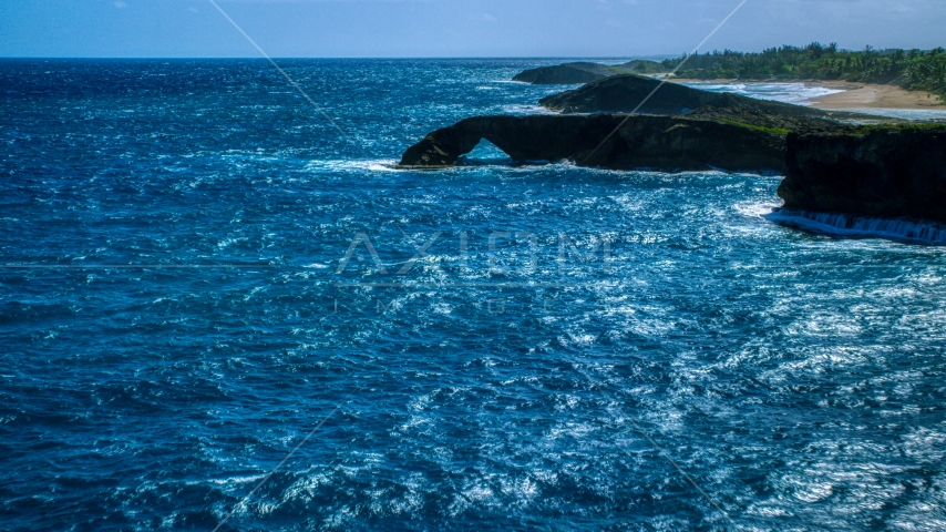 Arched rock formation in crystal blue water, Arecibo, Puerto Rico Aerial Stock Photo AX101_168.0000000F | Axiom Images