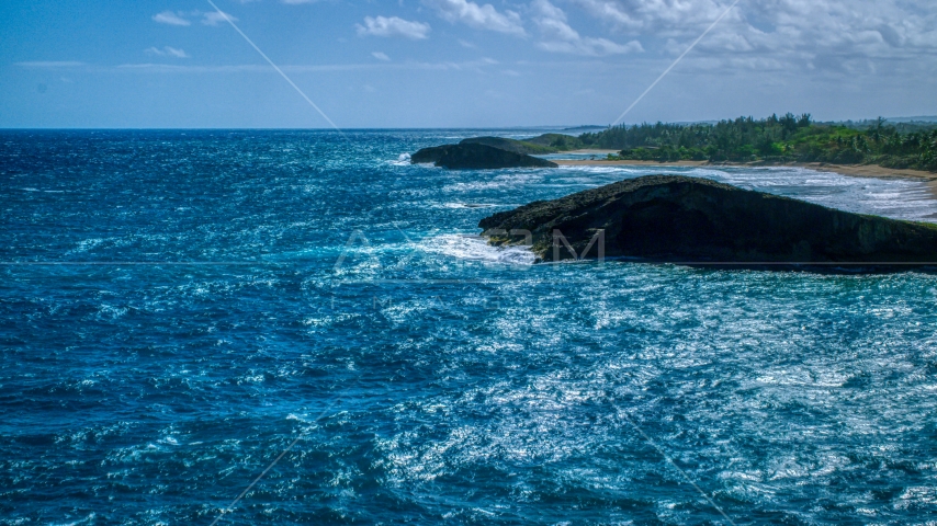 A pair of domed rock formations in crystal blue waters on the coast, Arecibo, Puerto Rico  Aerial Stock Photo AX101_170.0000000F | Axiom Images